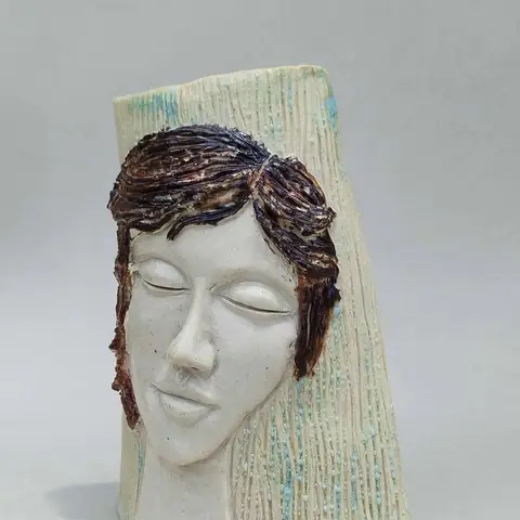 Face vessel with swept dark hair